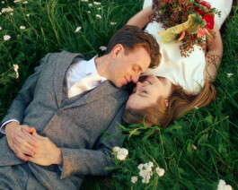 Couple lying in the grass during a sunset after-wedding shoot in Munich’s English Garden. 